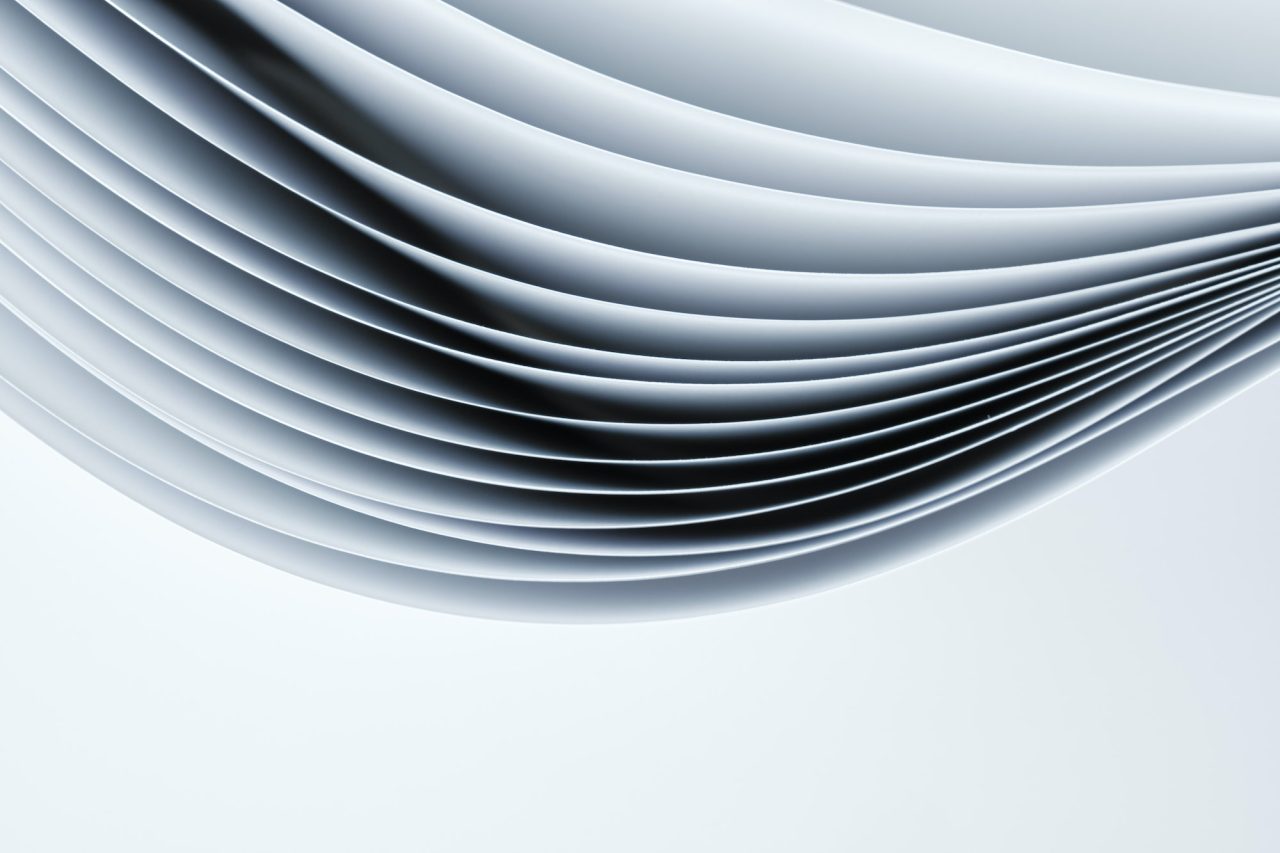 Abstract background, sheets of paper forming a pattern of curved lines.